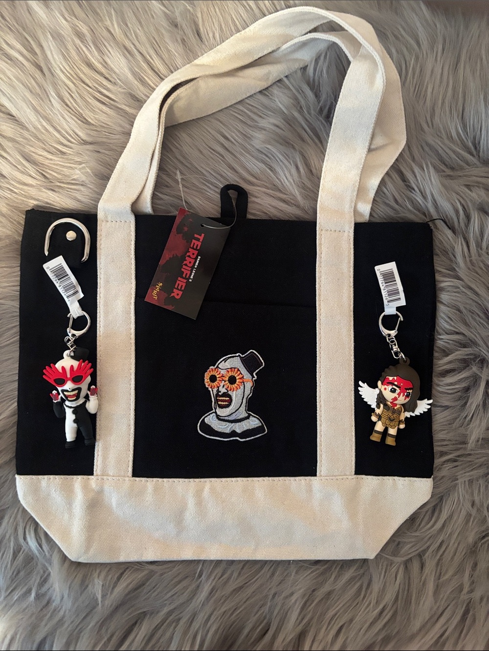 Spirit Halloween Terrifier tote bag with two bag clips